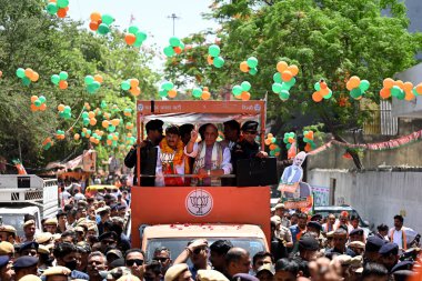 NEW DELHI, INDIA - MAY 1, 2024: BJP Delhi North East candidate for Lok Sabha election Manoj Tiwari along with Union Defence Minister Rajnath Singh at Yamuna Vihar during a roadshow before submitting the nomination, on May 1, 2024 in New Delhi, India. clipart