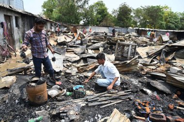 GURUGRAM, INDIA - MAY 18: Family members of victims arrive in the wreckage of a burned sleeper bus at Kundli-Manesar-Palwal (KMP) Expressway; a tourist bus carrying around 64 pilgrims from Punjab and Chandigarh  clipart