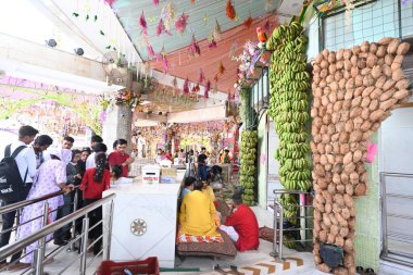 NEW DELHI, INDIA - APRIL 8, 2024: Workers decoration with flower preparation at Jhandewalan temple for Navratri festival on April 8, 2024 in New Delhi, India. (Photo by Sonu Mehta/Hindustan Times) clipart