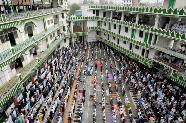 NOIDA, INDIA - APRIL 11, 2024:  Muslims offer prayers (namaz) on the occasion of Eid-Ul-Fitr at the Sector 8 Jama Masjid on April 11, 2024 in Noida, India.  Muslims around the world are getting into the festive Eid spirit as the holy month.  clipart