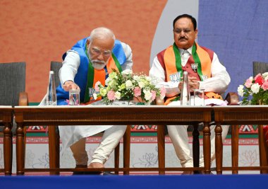 Prime Minister Narendra Modi and BJP President JP Nadda during the launch of BJP Sankalp Patra for Lok Sabha Elections 2024 at BJP HQ on April 14 2024 in New Delhi India clipart