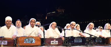 NEW DELHI, INDIA - APRIL 27, 2024: Sikh Women Kirtan - Group Women Satsang Sabha Delhi during the Delhi Fateh Diwas,(Delhi Victory Day) commemorating 400th birth anniversary of Mata Gujri Ji,organized by the Delhi Sikh Gurdwara Management Committee clipart