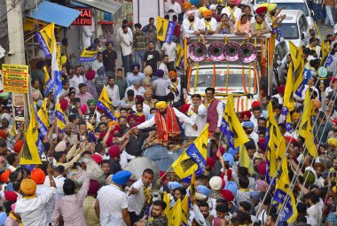 LUDHIANA, INDIA - APRIL 28: Punjab Chief Minister Bhagwant Mann, Aam Aadmi Party (AAP) candidate from Ludhiana Constituency Ashok Prashar with party leaders during a road show ahead of the Lok Sabha election, on April 28, 2024 in Ludhiana, India. clipart