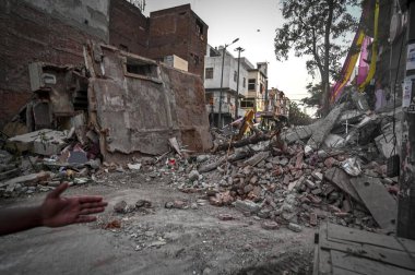 NEW DELHI, INDIA - APRIL 20: A view of EDMC workers cleaning the building's debris from the roadside after the Three-Storey building Collapses at the Kalyanpuri area, on April 20, 2024 in New Delhi, India clipart