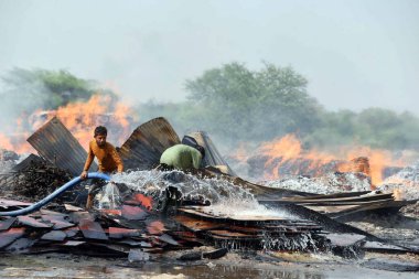 GURUGRAM, INDIA - APRIL 21: A massive fire broke out in a wooden material godown in Bajghera village near Dwarka expressway, fire department official said that no one was injured in this incident, on April 21, 2024 in Gurugram, India.  clipart