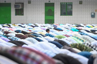 NOIDA, INDIA - APRIL 11, 2024:  Muslims offer prayers (namaz) on the occasion of Eid-Ul-Fitr at the Sector 8 Jama Masjid on April 11, 2024 in Noida, India.  Muslims around the world are getting into the festive Eid spirit as the holy month.  clipart