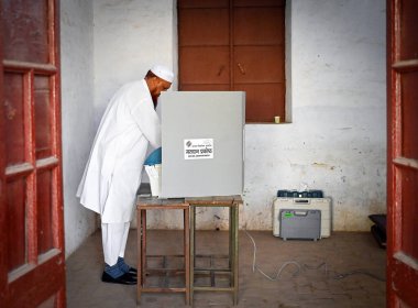 MUZAFFARNAGAR, INDIA - APRIL 19: A voter casts his vote during the First Phase of Lok Sabha elections 2024 at a polling station on April 19, 2024 in Muzaffarnagar, India. First phase of voting for the 2024 Lok Sabha election was held today, April 19. clipart