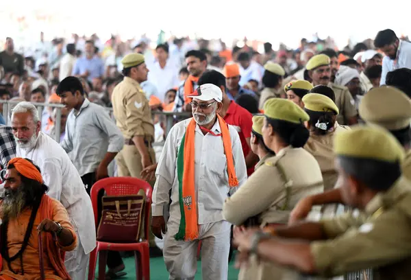 stock image BULANDSHAHR, INDIA - APRIL 18, 2024: People gather to attend the campaign rally for Lok Sabha Elections addressed by Chief Minister of Uttar Pradesh Yogi Adityanath in support of Gautam Budh Nagar constituency candidate Mahesh Sharma. 