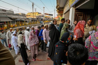 MEERUT, INDIA - APRIL 26: People are queuing up inside a polling station during the Second phase of the general Loksabha elections in rashid nagar lisari road, in the western state of Uttar Pradesh,  on April 26, 2024 in Meerut, India. clipart