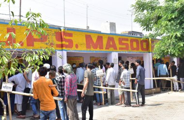 GHAZIABAD, INDIA - APRIL 26, 2024: People are queuing up outside a polling station during the Second phase of the general Loksabha elections at Kaila Bhatta polling booth on April 26, 2024 in Ghaziabad, India. (Photo by Sakib Ali/Hindustan Times) clipart