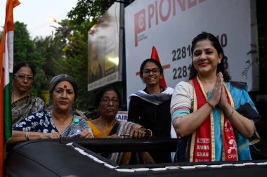 KOLKATA, INDIA - APRIL 27: CPI(M) candidate for South Kolkata Lok Sabha constituency Saira Shah Halim (R) with CPI(M) leader Brinda Karat (L) and Aishe Ghosh (R Behind) in a campaign rally at Golpark on April 27, 2024 in Kolkata, India.  clipart