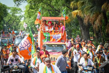 NEW DELHI, INDIA - APRIL 30, 2024: Basuri Swaraj, BJP's Candidate from New Delhi Constituency for upcoming Loksabha Elections seen along Delhi BJP President Virendra Sachdeva and BJP Leader Hardeep Puri during a Roadshow before filing her nomination. clipart