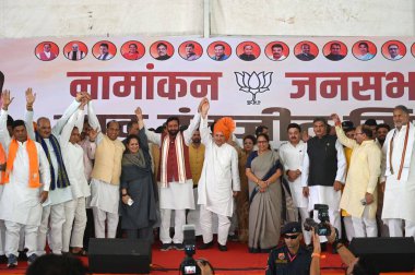 GURUGRAM, INDIA - APRIL 29, 2024: Chief Minister of Haryana, Nayab Singh Saini, Union Minister of State and BJP Gurugram parliamentary constituency candidate, Rao Inderjit Singh and Former MP Sudha Yadav during the nomination rally at Civil line  clipart