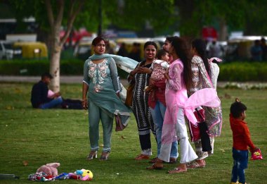 NEW DELHI, INDIA - APRIL 13: Visitors at Kartavaya Path as Clouds and strong wind blow over Kartavya Path , on April 14, 2024 in New Delhi, India. IMD said that due to the influence of several weather systems clipart