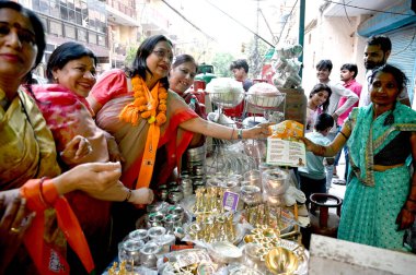 NOIDA, INDIA - APRIL 8: Uma Sharma, wife of BJP candidate from Gautam Buddh Nagar parliamentary constituency Dr. Mahesh Sharma and other BJP worker doing door to door campaigning for Lok Sabha elections in Sector 15 on April 8, 2024 in Noida, India.  clipart