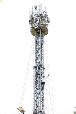 Two Tamil Nadu protesting farmers climbed a mobile tower for their various demands near Jantar Mantar rescued by the Firemen ,  on April 24, 2024 in New Delhi, India.   clipart