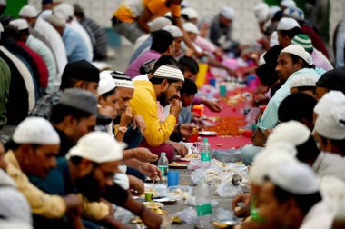 NOIDA, INDIA - 10 Nisan 'da, Müslümanlar 10 Nisan 2024 tarihinde Hindistan' ın Noida kentinde, Sektör 8 'de sürmekte olan Ramazan ayı boyunca, Jama Mescidi' nde iftar yemeği (Roza) ile oruç tutmadan önce dua ederler.. 