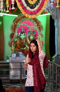 NOIDA, INDIA - APRIL 17, 2024: Devotees pray on the occasion of Rama Navami festival at Sanatan Dharam mandir on April 17, 2024 in Noida, India. clipart