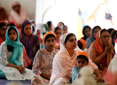NoIDA, INDIA - 13 Nisan 2024 'te Hindistan' ın Noida kentinde, Baisakhi vesilesiyle, 18. Sektör 'deki bir Gurudwara' da namaz kılanlar. Baisakhi ya da Vaisakhi, Vaisakh ayının ilk gününü kutlayan popüler bir bahar festivali.
