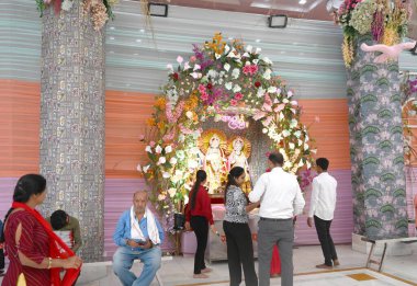 NEW DELHI, INDIA - APRIL 8, 2024: Workers decoration with flower preparation at Jhandewalan temple for Navratri festival on April 8, 2024 in New Delhi, India. (Photo by Sonu Mehta/Hindustan Times) clipart