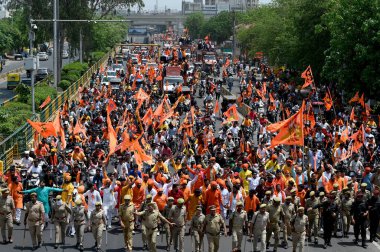 NOIDA, INDIA - APRIL 28: Vishwa Hindu Parishad and Bajrang Dal workers took out a procession from Kashiram Colony Sector 45 on the occasion of Hanuman Janmotsav, on April 28, 2024 in Noida, India.  clipart