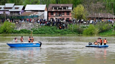 SRINAGAR, INDIA - APRIL 16: National Disaster Response Force (NDRF) team conduct rescue operation after boat capsized in the jhelum river on April 16, 2024 in Srinagar, India.  clipart