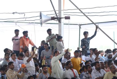 BULANDSHAHR, INDIA - APRIL 18, 2024: People gather to attend the campaign rally for Lok Sabha Elections addressed by Chief Minister of Uttar Pradesh Yogi Adityanath in support of Gautam Budh Nagar constituency candidate Mahesh Sharma.  clipart