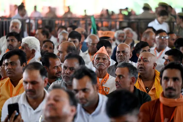 stock image GREATER NOIDA, INDIA - APRIL 2, 2024 :  People gather to attend the campaign rally for Lok Sabha Elections addressed by Ministry of Defence Rajnath Singh at Bisahda village Dadri 