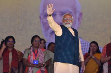 NORTH 24 PARGANAS, INDIA - MARCH 6, 2024: Prime Minister Narendra Modi greets supporters during Narishakti Vandana Rally organised by Bharatiya Janata Party and Bharatiya Janata Mohila Morcha at Barasat   clipart