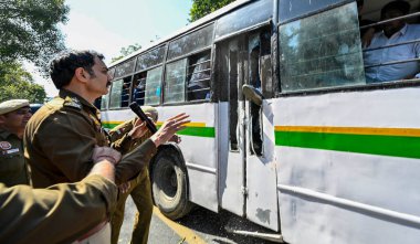 NEW DELHI, INDIA - MARCH 5, 2024: Delhi Police and Paramilitary Security forces try to detaining Akhil Bharatiya Vidyarthi Parishad (ABVP) activists during the demonstration against Mamata Banerjee's government to demand justice for women. clipart