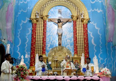 NOIDA, Hindistan - 31 Mart 2024: Paskalya gününde Sektör-34 'teki bir kilisede rahip namaz kılıyor. Paskalya, İsa 'nın çarmıha gerilmesinin ardından yeniden dirilişini kutlamak için kutlanır..