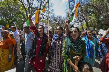 NEW DELHI, INDIA - MARCH 15, 2024: Hindu Refugees from Pakistan and Afghanistan stage a protest against Congress Party over alleged Anti-CAA remarks near AICC headquarters on March 15, 2024 in New Delhi, India. Refugees from Pakistan and Afghanistan. clipart