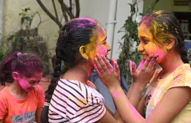 NEW DELHI, INDIA - 24 Mart 2024: Holi arifesinde Gulal ile oynayan çocuklar, 24 Mart 2024 'te Yeni Delhi, Hindistan' da. 