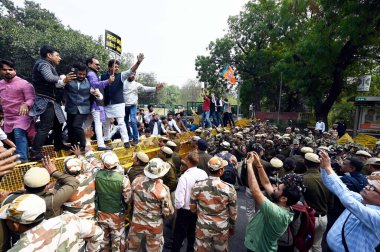 NEW DELHI, INDIA - MARCH 1, 2024: BJP President Virendra Sachdeva attempts to cross police barricades during a protest against the West Bengal government over Sandeshkhali issue, near Bang Bhawan, Chanakyapuri on March 1, 2024 in New Delhi, India. clipart