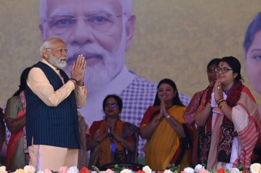 NORTH 24 PARGANAS, INDIA - MARCH 6, 2024: Prime Minister Narendra Modi greets supporters during Narishakti Vandana Rally organised by Bharatiya Janata Party and Bharatiya Janata Mohila Morcha at Barasat   clipart