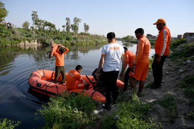 NOIDA, INDIA - 15 Mart 2024: 80. Sektör Kakrala Pusta 'da Hindistan cevizi yakalarken boğulduğu bildirilen çocukları arayan Ulusal Afet Müdahale Gücü (NDRF) personeli