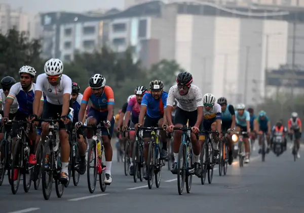 stock image GREATER NOIDA, INDIA - MARCH 17: Cyclists participate in a 55 kilometers long Cyclothon near Gaur city mall road, on March 17, 2024 in Greater Noida, India. HCL Cyclothon was organized under the aegis of Cycling Federation of India 