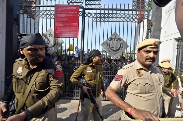 stock image NEW DELHI, INDIA - MARCH 12, 2024: Security personnel stand guard outside the Jamia Millia Islamia a day after the Ministry of Home Affairs notified the rules for implementation of the Citizenship (Amendment) Act on March 12, 2024 in New Delhi, India