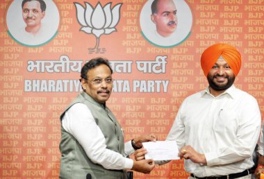 NEW DELHI, INDIA - MARCH 26: Ravneet Singh Bittu former Congress MP from Punjab Joins BJP in the presence of BJP National Gen Secy Vinod Tawde at BJP HQ at DDU Marg on March 26, 2024 in New Delhi, India. clipart