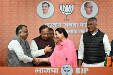 NEW DELHI, INDIA - MARCH 14: Ex-Punjab CM Amarinder Singh's wife and congress MP Preneet Kaur joins BJP in presence of BJP Punjab Chief Sunil Jakhar, Sr. BJP Leader Tarun Chugh and Vijay Rupani, Arun Singh, Vinod Tavede at BJP headquarters clipart