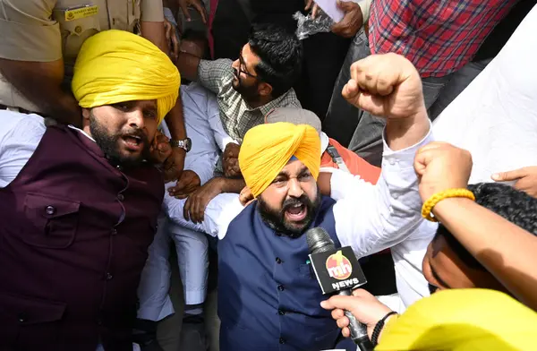 stock image NEW DELHI, INDIA - MARCH 26, 2024: Security personnel detain AAP workers during their protest outside Patel Chowk metro station against the arrest of Delhi CM Arvind Kejriwal, on March 26, 2024 in New Delhi, India.