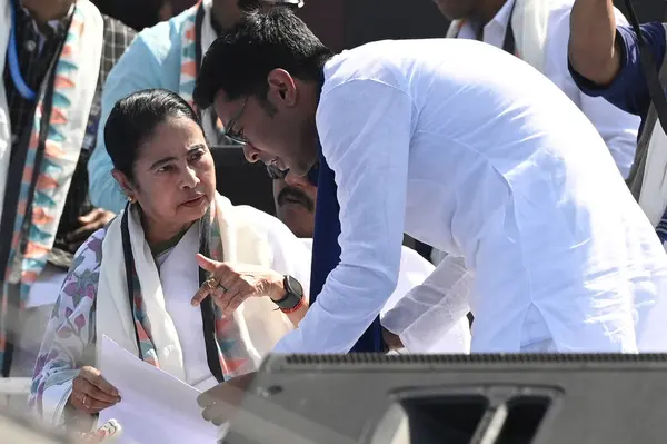 stock image KOLKATA, INDIA - MARCH 10: Chief Minister of West Bengal and All India Trinamool Congress (AITC) Chairperson Mamata Banerjee interacts with AITC General Secretary Abhishek Banerjee during 'Jonogorjon' Rally and launched her party's Lok Sabha campaign