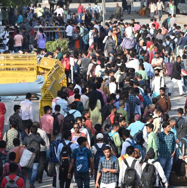 NEW DELHI, INDIA - MARCH 23, 2024: Passengers waiting for their Bus at Anand Vihar Railway Station, going to their home destination for celebration Holi Festival, on March 23, 2024 in New Delhi, India.  clipart