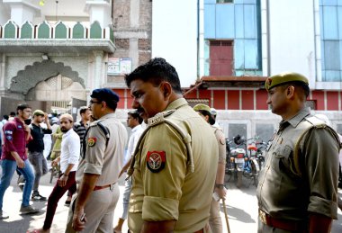 NOIDA, INDIA - MARCH 29, 2024: Noida Police personnel conducted a flag march in Sector 8 as security measures heightened following the demise of gangster-turned-politician Mukhtar Ansari, who passed away due to cardiac arrest at a hospital in Banda. clipart