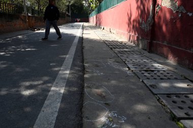 NEW DELHI, INDIA - FEBRUARY 25, 2024: Delhi police mark the spot after a 18 month old child died after street dogs attack and bite during yesterday evening at Tughlak lane Dhobi Ghat, on February 25, 2024 in New Delhi, India.  clipart