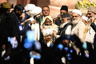 NEW DELHI, INDIA - FEBRUARY 25, 2024: Shahi Imam of Jama Masjid Syed Ahmed Bukhari declares his son Syed Usama Shaban Bukhari successor during a Dastarbandi ceremony on the 15th night of Shaaban (Islamic Month) at Jama Masjid on the late night. clipart