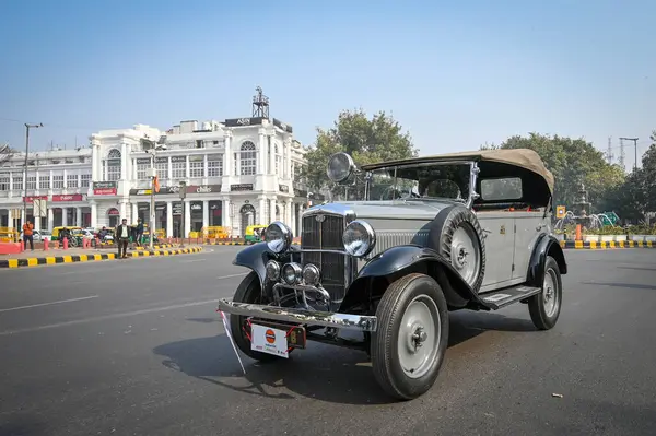 stock image NEW DELHI, INDIA - FEBRUARY 11, 2024: Vintage cars make their way through a road as they participate during the 57th Statesman Vintage & Classic Car Rally at Connaught Place on February 11, 2024 in New Delhi, India.