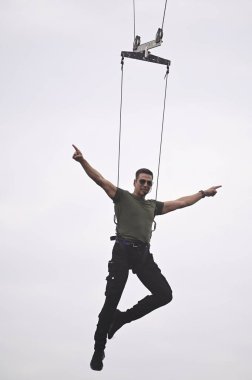 LUCKNOW, INDIA - FEBRUARY 26, 2024: Bollywood actor Akshay Kumar performs a stunt during the promotion of their upcoming movie 'Bade Miyan Chote Miyan' near the clock tower old city on February 26, 2024 in Lucknow, India clipart