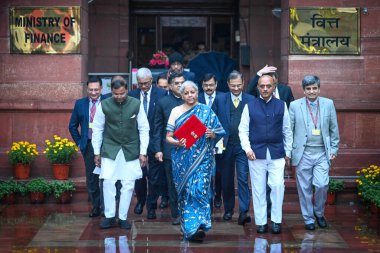 NEW DELHI, INDIA - FEBRUARY 1, 2024: Nirmala Sitharaman, Union Minister of Finance along with Bhagwat Karad and Pankaj Chaudhary MOS Finance leaves the Finance Ministry carrying the Finance Budget ahead of the presentation of interim Budget 2024. clipart