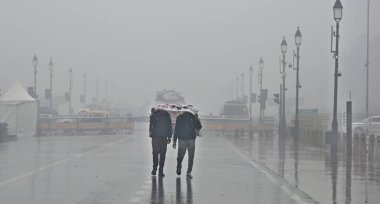 NEW DELHI, INDIA - JANUARY 31: Visitors protect themselves from sudden rain at Kartavya Path, on January 31, 2024 in New Delhi, India. clipart